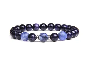 Beaded bracelet detail showing polished dark blue stone beads and metal spacers clearly.