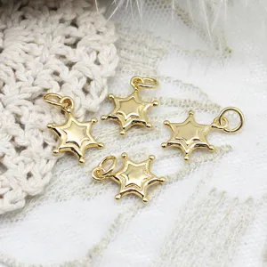 Detailed view of four golden star-shaped pendants for DIY necklaces and earrings.