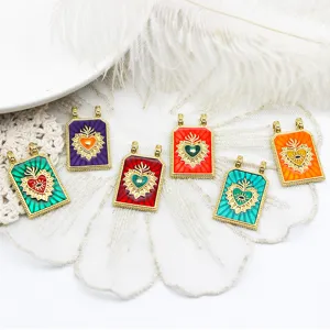 Close-up of colorful vintage Sacred Heart and Evil Eye rectangular pendants for DIY.