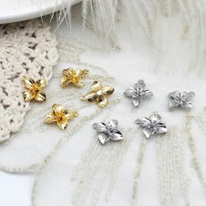 Detailed close-up showing gold and silver mini flower charms for DIY jewelry and crafts.
