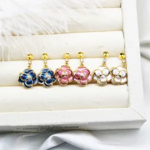 Close-up of floral enamel jewelry components for DIY earrings in white display box.