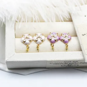 Detailed view of DIY flower-shaped earring studs in purple and white enamel finish