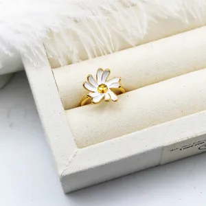 Detail view of white enamel daisy ring with 18K gold plated adjustable band