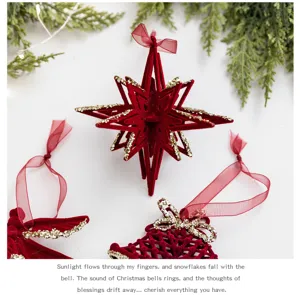 Macro view of red flocked Christmas star and bell ornaments with gold glitter edges.