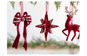 Detailed view of burgundy flocked Christmas tree ornaments featuring gold glitter accents