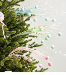 Detail view of decorative Christmas tree firework sprays with colorful pastel pom-poms.