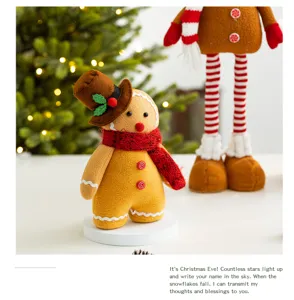 Adorable gingerbread man plush figure with red scarf and hat on a festive background
