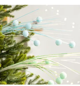 Detail of glitter Christmas willow branches with soft pastel pom-poms on a tree deco.