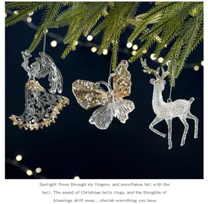 Detailed view of transparent acrylic Christmas ornaments with gold sequins hanging on pine