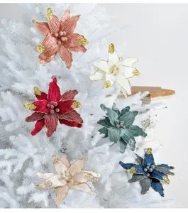 Close-up of multicolored velvet Christmas flowers with glitter on a white tree.