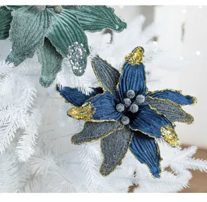 Macro view of an artificial Christmas flower decoration with blue petals and gold glitter