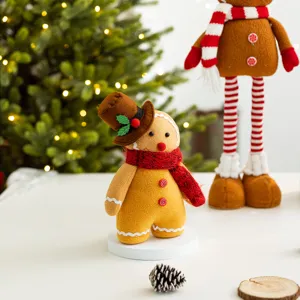 Adorable plush gingerbread man Christmas decoration wearing a top hat and red knit scarf