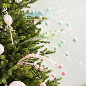 Festive pastel Christmas tree twig ornaments with soft colorful pom-poms for DIY decor