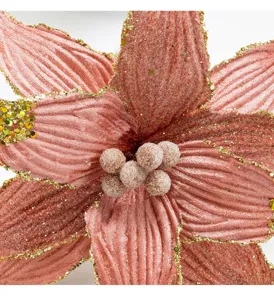 Macro detail of champagne velvet Christmas flower with golden glitter edges for DIY decor.