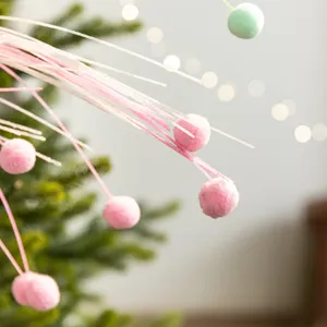 Festive Christmas decorative branches with pink pom-poms and glittery stems for DIY