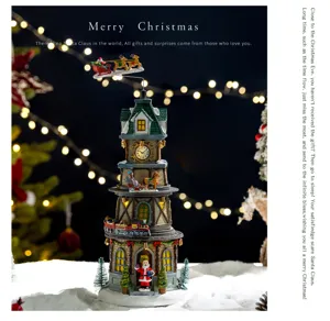Detailed view of the festive Christmas tower with rotating train and warm lighting