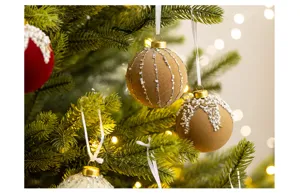 Close-up of elegant flocked Christmas ornaments with pearl and star bead details