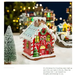 Lit-up red Christmas gingerbread house ornament with decorative snow and glitter details