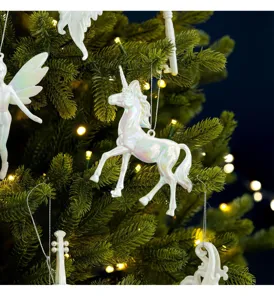 Detail of iridescent white unicorn Christmas tree ornament in a festive holiday scene