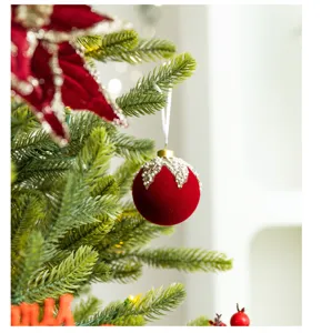 Close-up of a burgundy flocked Christmas ball ornament with decorative pearl and gold accents