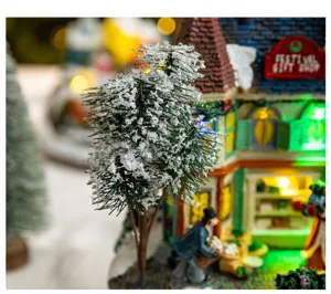 Close-up detail of a snowy Christmas gift shop house with festive warm lighting