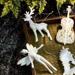 Elegant pearlescent white Christmas ornaments featuring angel deer and violin figurines