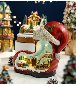 Intricate LED Christmas boot ornament featuring a miniature snowy village and train