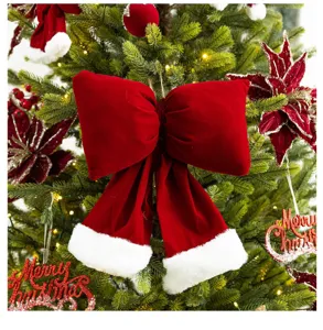 Detail of a large burgundy velvet bow with white faux fur trim on a Christmas tree
