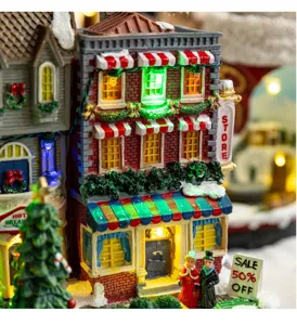 Close-up of glowing Christmas village store with miniature figures and LED lights