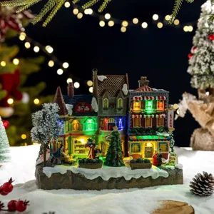 Glowing Christmas village house ornament with LED lights and festive winter decorations