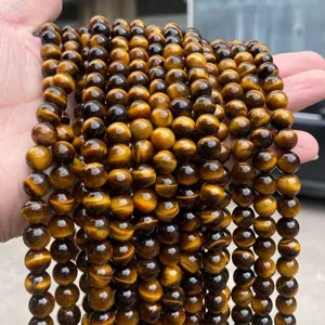 Macro detail of polished natural yellow tiger's eye round beads for jewelry DIY.