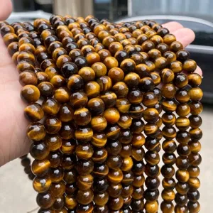 Macro view of natural yellow tiger eye round beads with high chatoyancy texture