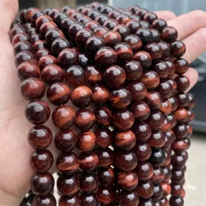 Macro detail showing textures of natural red tiger eye stone beads for DIY jewelry making