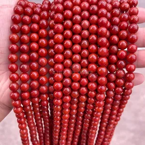 Close-up of vibrant persimmon red South Red agate round beads for DIY jewelry making