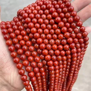 Detailed view of natural red Nan Hong Agate loose round beads for DIY jewelry crafts