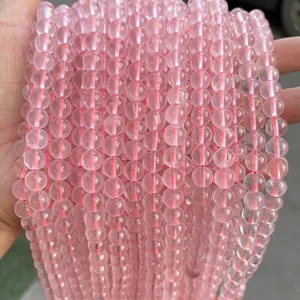 Close-up of 8mm natural ice rose quartz round loose beads for DIY jewelry
