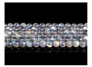 Nahaufnahme von natürlichen 6mm grauen Mondsteinperlen mit blauem Schimmer