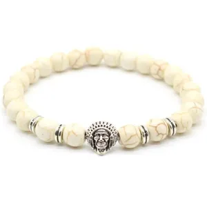 Close-up detail of beaded bracelet featuring 8mm white stone beads and metallic chief charm.
