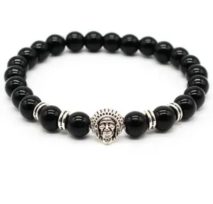 Close-up detail of black stone bead bracelet with vintage tribal chief charm and spacers.