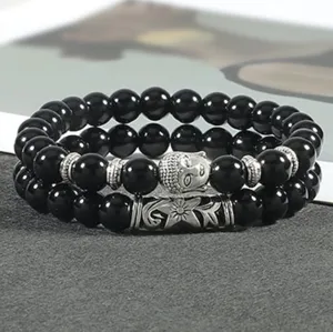 Gedetailleerd overzicht van de zwarte kralen yoga armband in twee delen met Boeddha hanger.