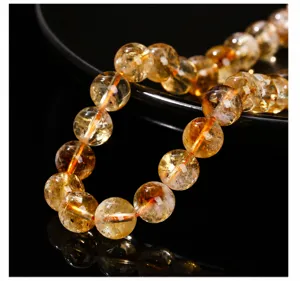 Close-up macro view of yellow citrine quartz beads showing natural internal textures