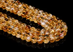 Close-up detail of polished yellow citrine crystal beads with high clarity for DIY jewelry