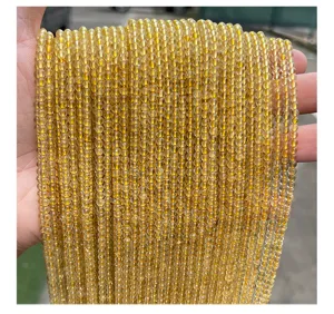 Macro view of 3mm natural golden rutilated quartz round beads for DIY jewelry making.