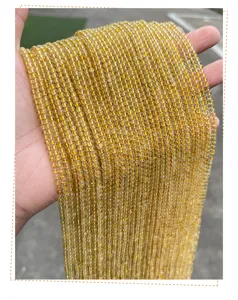 Detailed macro view showing the natural texture of 3mm gold rutilated quartz beads strands.