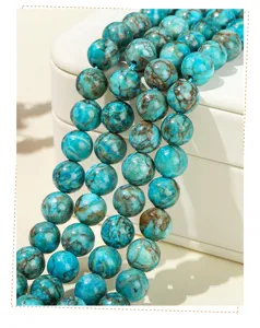 Macro detail shot showing the rich texture of blue turquoise round beads with brown veins.