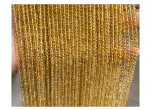 Macro view of 3mm natural gold rutilated quartz beads showing fine golden rutiles