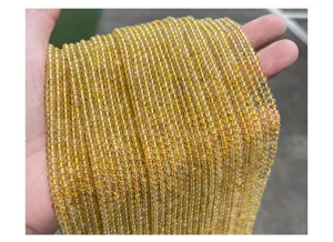 Macro detail of 3mm natural golden rutilated quartz crystal beads for jewelry making
