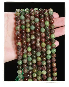 Macro view of natural green and brown textured stone round beads for DIY jewelry