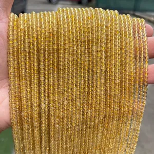 Hand-held strands of 3mm natural golden rutilated quartz round beads for DIY jewelry