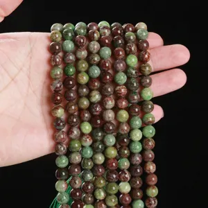 Natural green patterned stone round beads for DIY jewelry making and bracelet assembly.